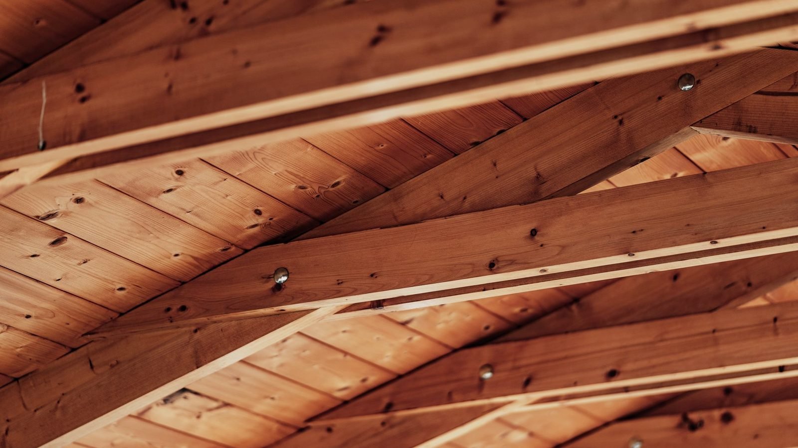 Dry ice blasting cleaning mold from floor joists in a residential crawl space